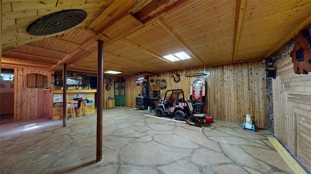 basement featuring wood walls