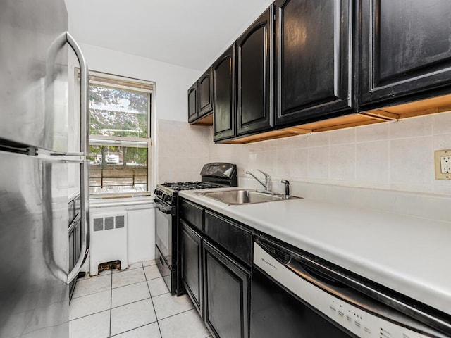 144 Ravine Ave Unit 2C, Yonkers, NY 10701 - kitchen with freestanding refrigerator, radiator, dishwashing machine, black range with gas cooktop, and a sink
