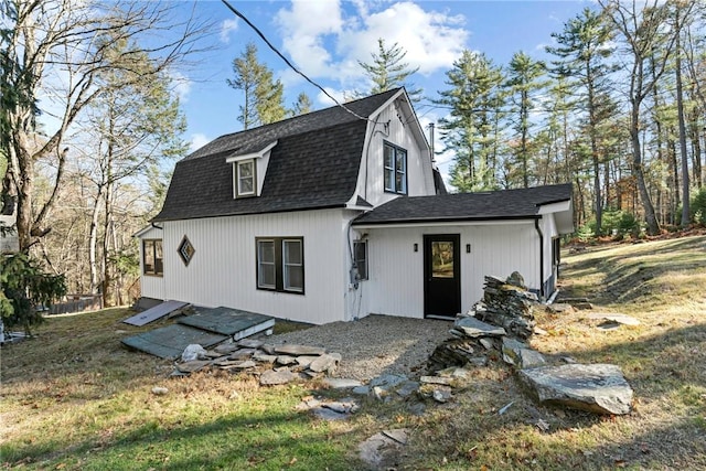 rear view of property featuring a yard