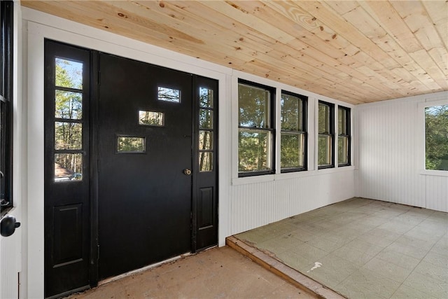 interior space featuring plenty of natural light, wood walls, and wooden ceiling