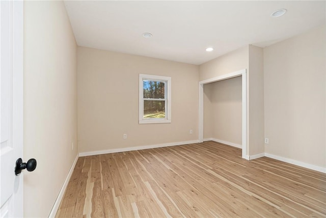 unfurnished bedroom with light hardwood / wood-style floors and a closet