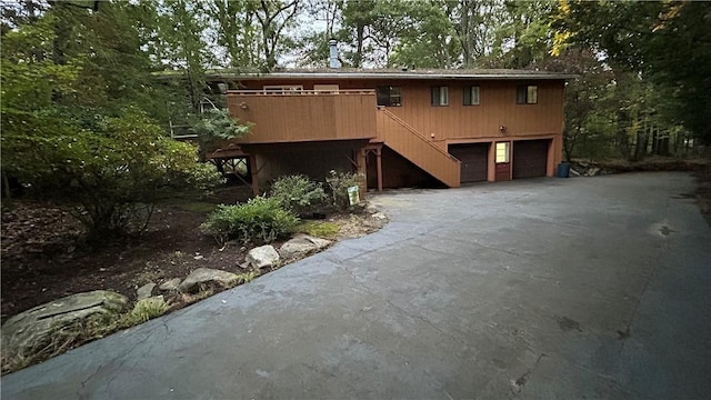 view of front of house with a garage and a wooden deck