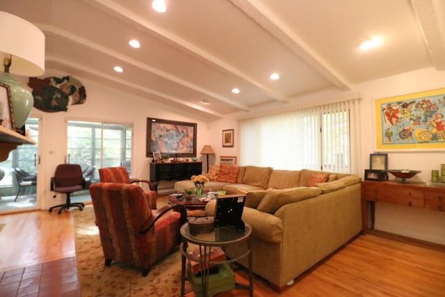 living room featuring lofted ceiling with beams and light hardwood / wood-style floors