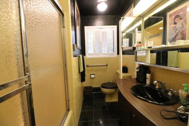 full bathroom with tile patterned floors, vanity, toilet, and shower / bath combination with glass door