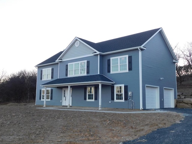 view of front of home with a garage and covered porch