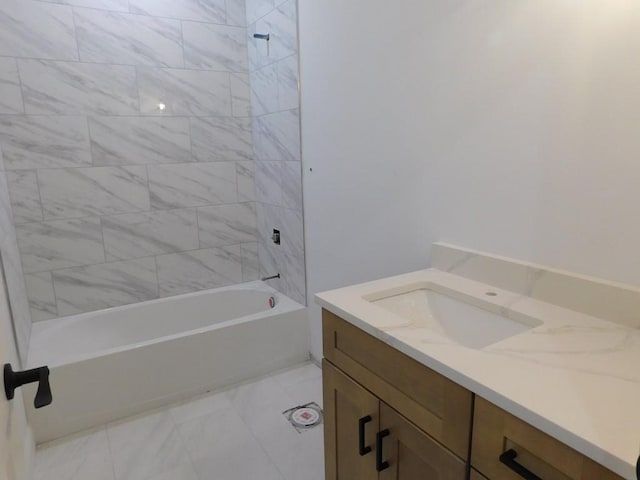 bathroom with vanity and tiled shower / bath