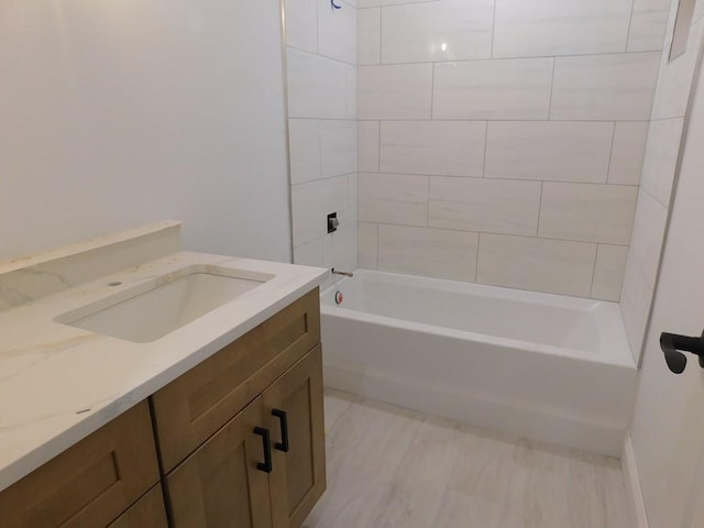 bathroom featuring vanity and tiled shower / bath combo