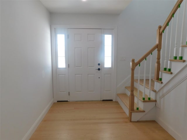 foyer featuring light wood-type flooring and a healthy amount of sunlight