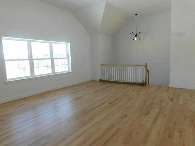 additional living space featuring light hardwood / wood-style flooring and lofted ceiling