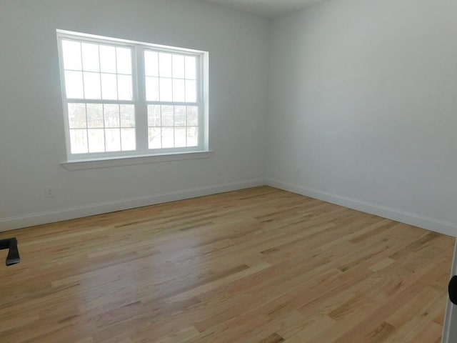 spare room featuring light hardwood / wood-style floors