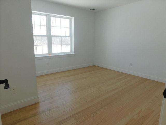 spare room featuring light wood-type flooring