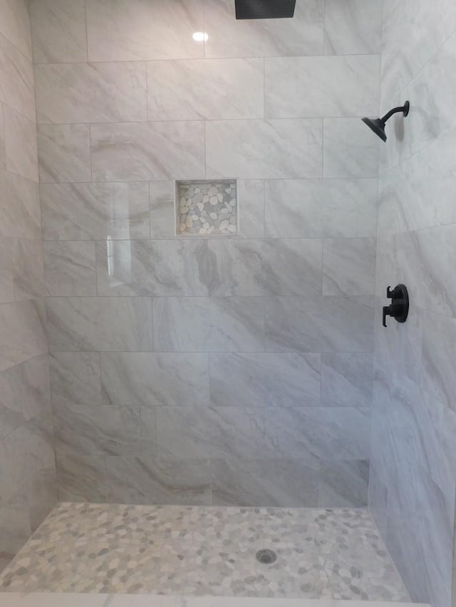 bathroom with tiled shower