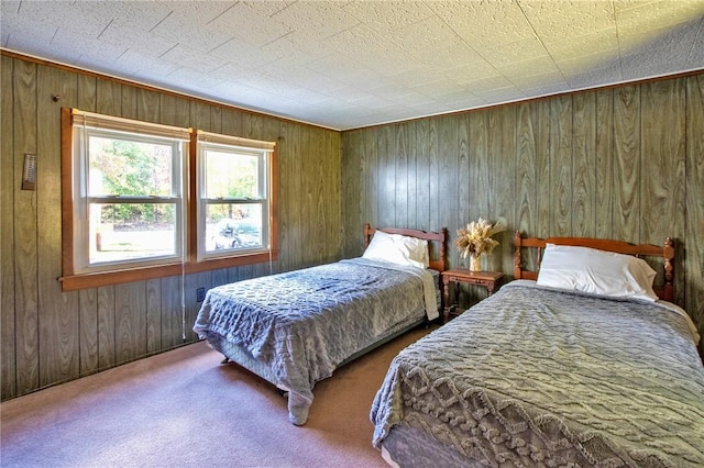 carpeted bedroom featuring wood walls