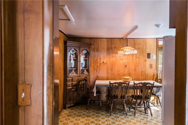 dining space with wooden walls