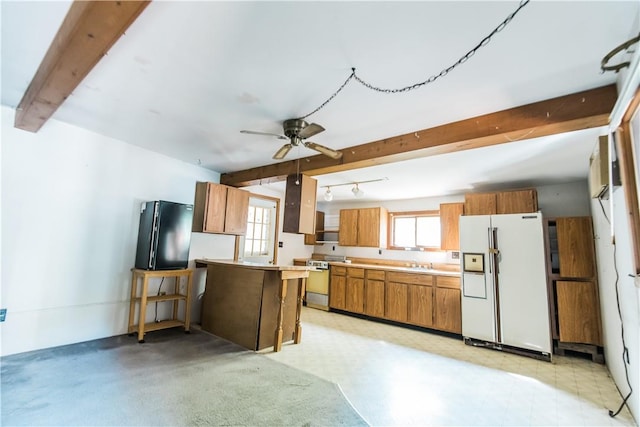 kitchen featuring black refrigerator, sink, ceiling fan, white fridge with ice dispenser, and beamed ceiling