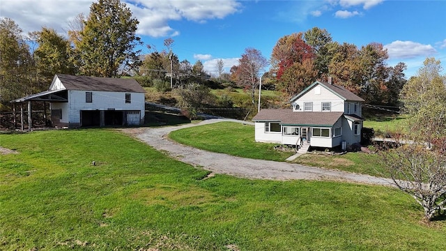 view of home's exterior with a porch, a garage, and a yard