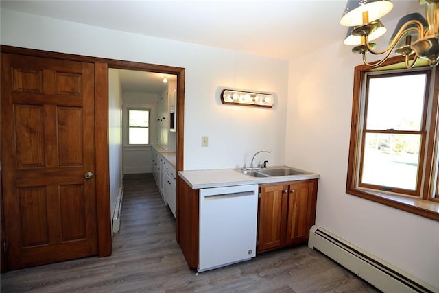 kitchen with dark hardwood / wood-style flooring, white dishwasher, baseboard heating, and sink