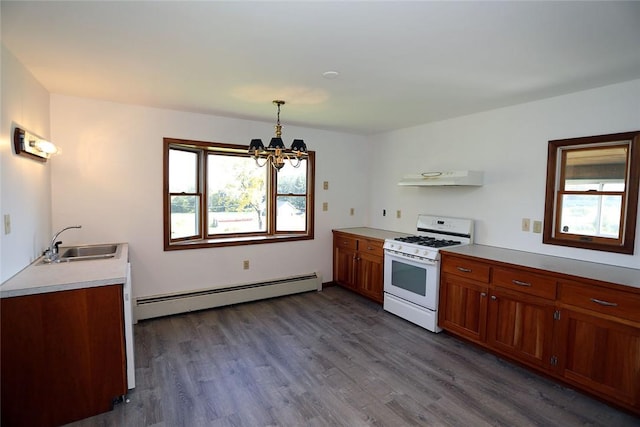 kitchen with pendant lighting, sink, dark hardwood / wood-style floors, a baseboard radiator, and white gas stove