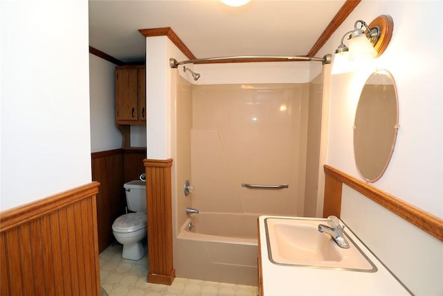 full bathroom featuring  shower combination, toilet, ornamental molding, and sink