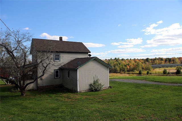 view of side of property with a lawn