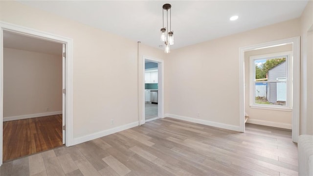 unfurnished dining area featuring light wood-type flooring and radiator heating unit