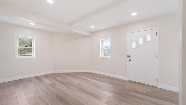 entrance foyer with beamed ceiling and light hardwood / wood-style flooring