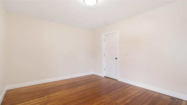 unfurnished room with wood-type flooring