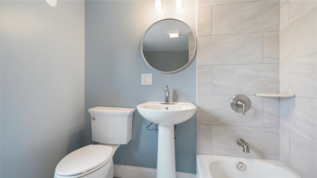 bathroom featuring a tub and toilet