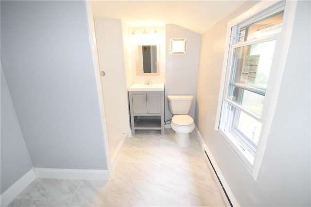 bathroom featuring vanity, toilet, baseboard heating, and vaulted ceiling