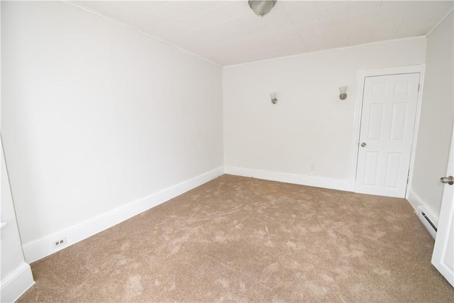 unfurnished room featuring carpet flooring and baseboard heating