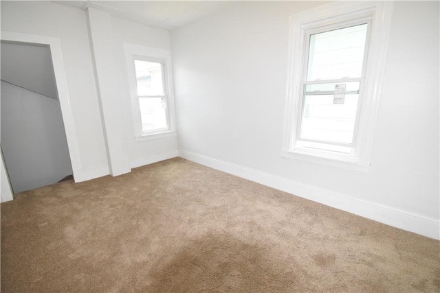 unfurnished bedroom featuring light carpet