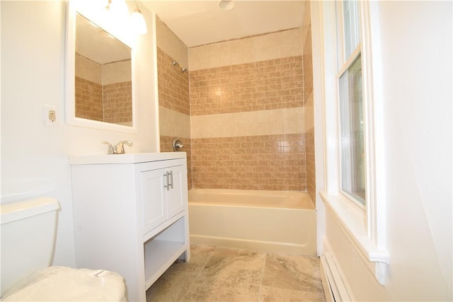 full bathroom with vanity, toilet, and tiled shower / bath