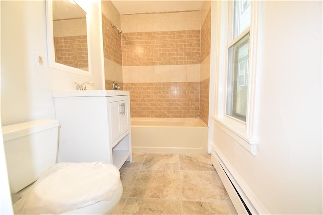 full bathroom featuring vanity, toilet, tiled shower / bath, and a baseboard radiator