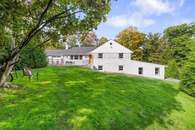 back of property featuring a lawn