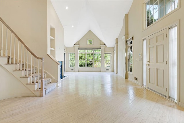 foyer featuring light hardwood / wood-style floors and high vaulted ceiling