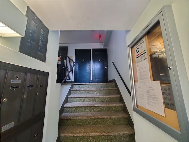 staircase featuring mail boxes