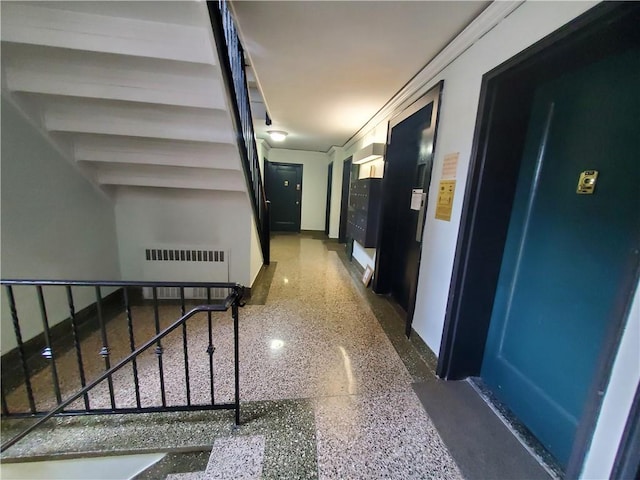 hallway with radiator heating unit and ornamental molding