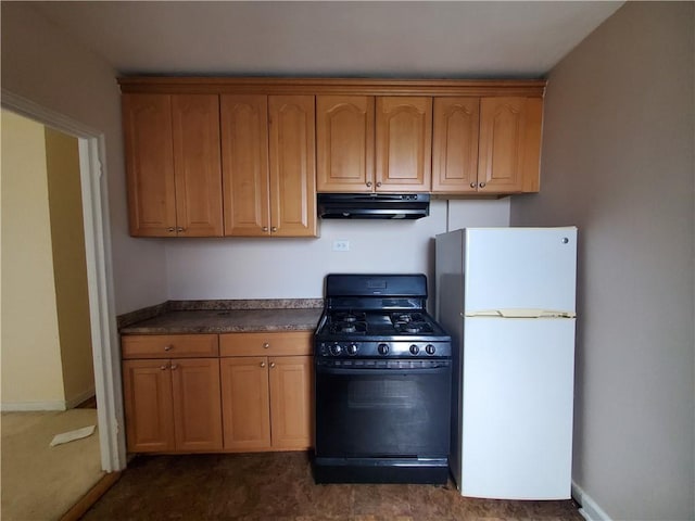 kitchen featuring gas stove and white fridge