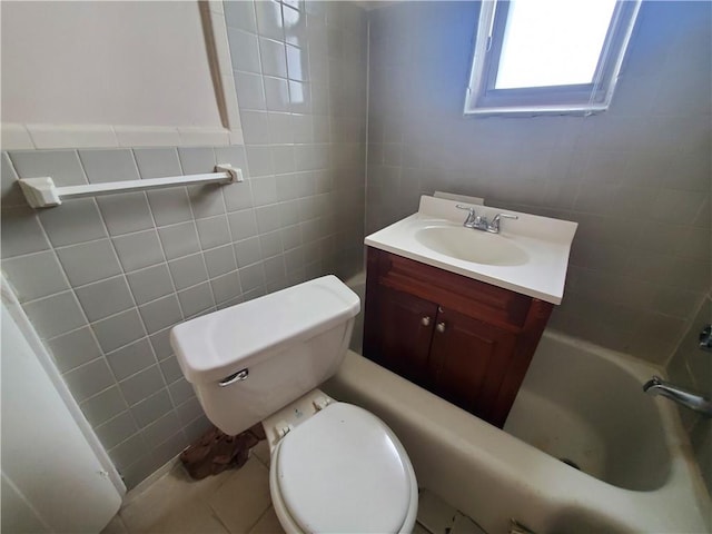 full bathroom featuring vanity, tile patterned floors, washtub / shower combination, toilet, and tile walls