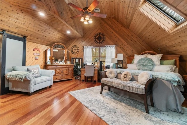 bedroom with a skylight, wood ceiling, high vaulted ceiling, hardwood / wood-style floors, and wood walls