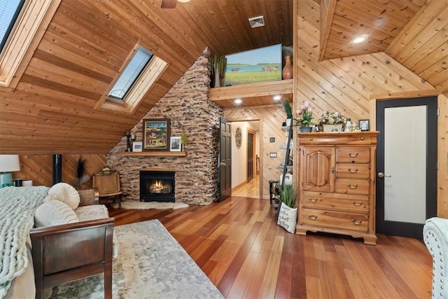 living room with wood walls, a fireplace, wooden ceiling, and wood-type flooring