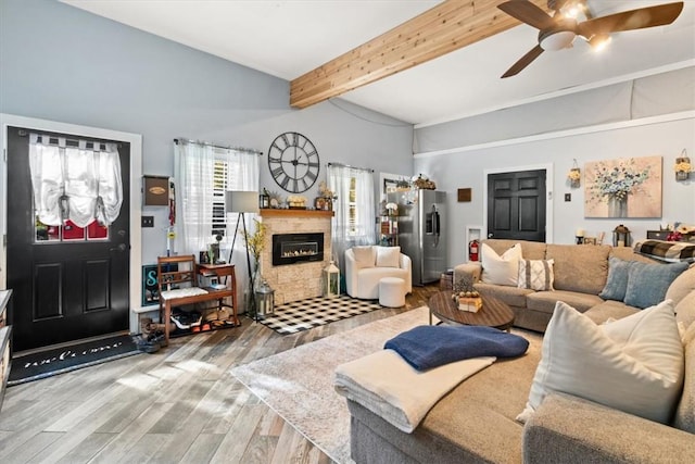 living room with beam ceiling, hardwood / wood-style flooring, high vaulted ceiling, and ceiling fan