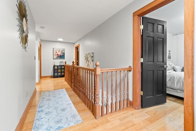 corridor with light hardwood / wood-style flooring