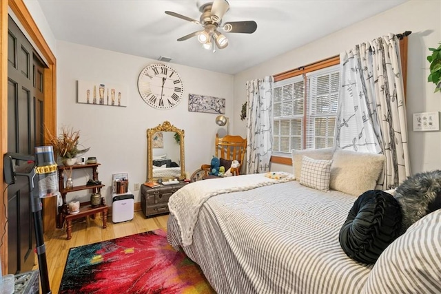 bedroom with ceiling fan and light hardwood / wood-style floors