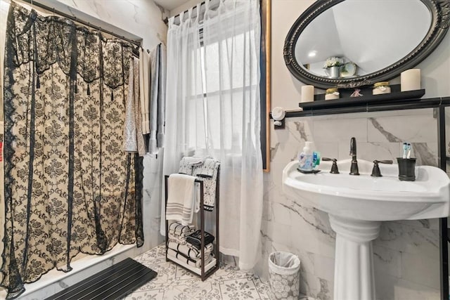 bathroom with tile walls and walk in shower