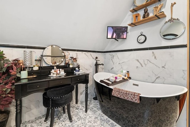 bathroom with tile walls and a tub