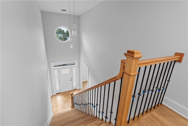 staircase with hardwood / wood-style floors