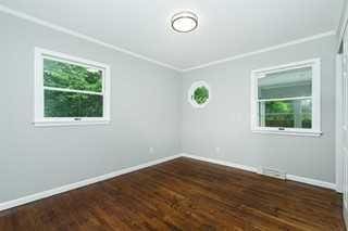 spare room with dark hardwood / wood-style flooring