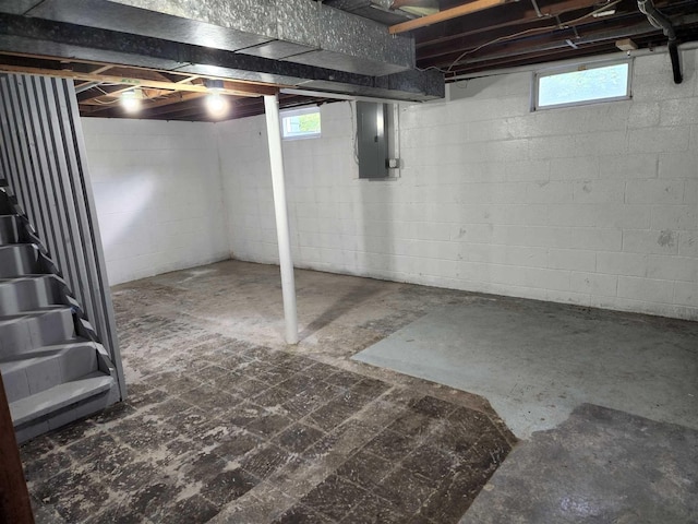 basement featuring electric panel and plenty of natural light