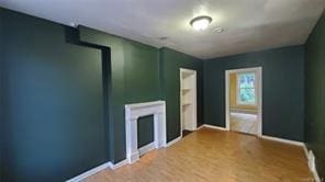 unfurnished living room featuring wood-type flooring